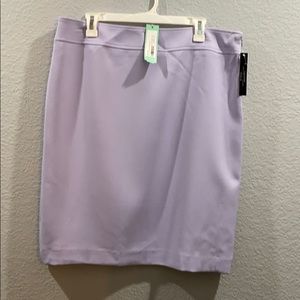 Light purple knee length skirt with back slit.